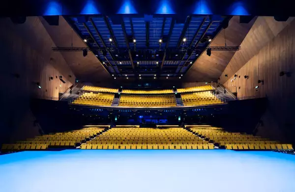 Photo of the stage and yellow seats in the Hall