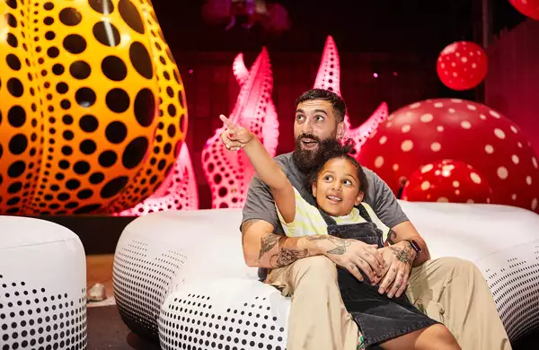 A father and daughter enjoy Yayoi Kusama: You, Me and the Balloons at Aviva Studios