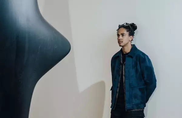 Photograph of Mac Collins with his sculpture