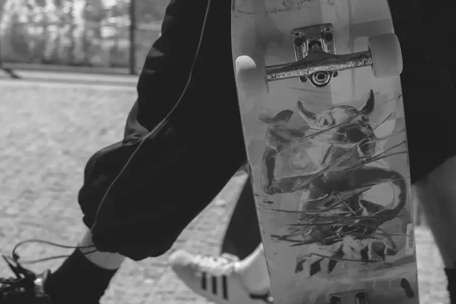 Black and white photograph of a decorated skateboard