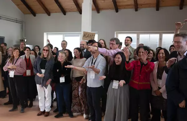 A large group of people stood up smiling