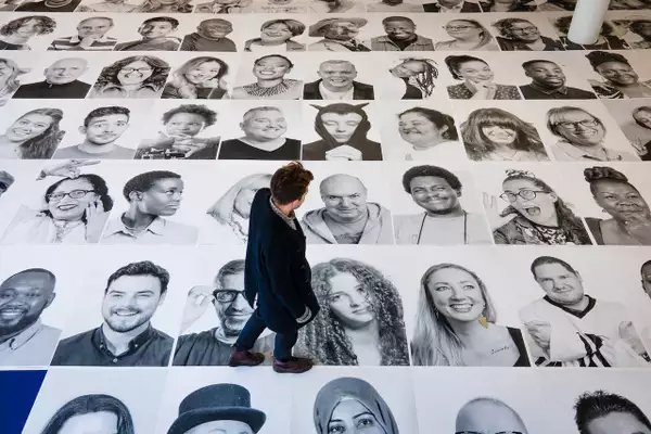 Someone walking over the black and white Inside Out portraits on the ground