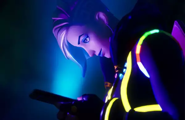 A screenshot of LaTurbo Avedon in Fortnite Creative - they are shot from the left side, and their face is lit by the blue light of the phone they are looking at.