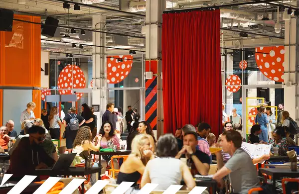 People sat socialising in a cafe at tables