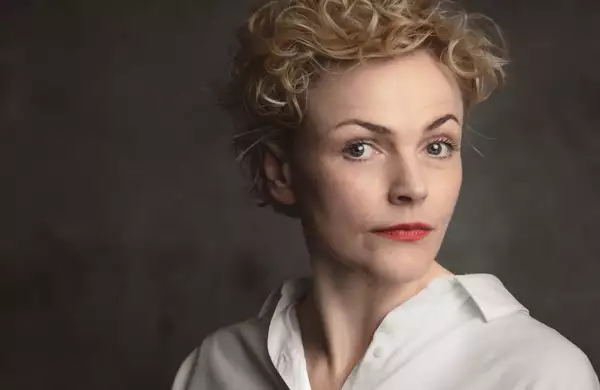 A headshot of the actor Maxine Peake wearing a white shirt