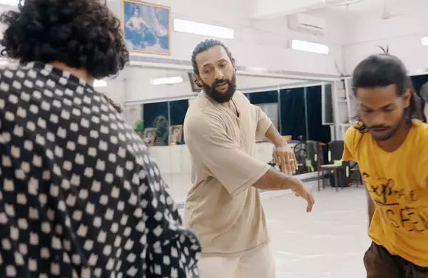 Terence Lewis directing three people in a rehearsal room