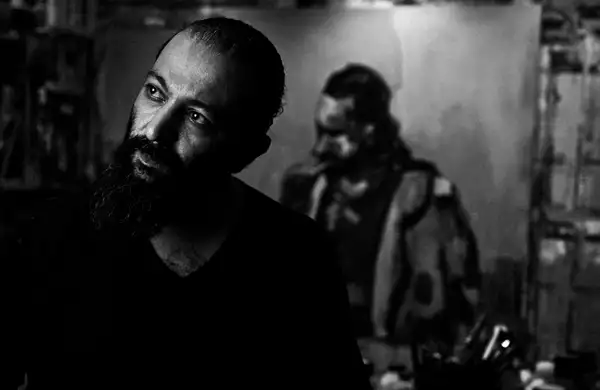 A black and white self portrait of artist Shareef Sarhan