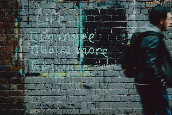 Graffiti on a brick wall that reads 'Life: Do More, Have More, Bicycle'