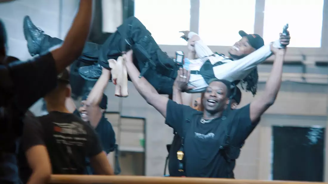 A still from In the Studio with Ivan Michael Blackstock, showing a group of dancers holding a dancer in the air next to a mirror