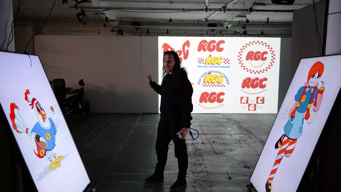 Robin McNicholas stood in front of three large screens showcasing the branding behind his upcoming show Sweet Dreams