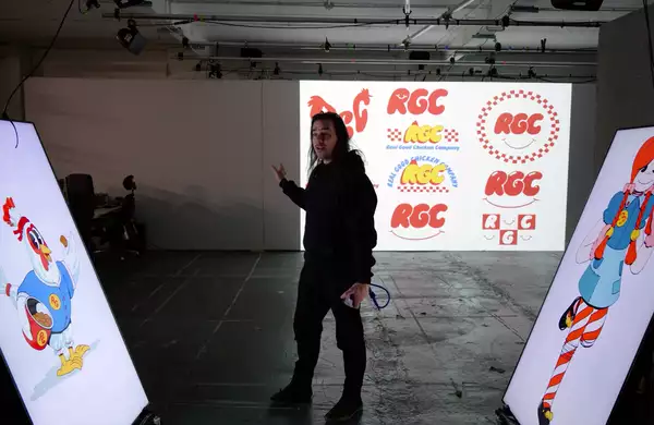Robin McNicholas stood in front of three large screens showcasing the branding behind his upcoming show Sweet Dreams